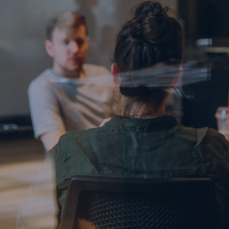Two marketing professionals in a meeting at a Bolton digital marketing agency, discussing strategy and ideas to help businesses grow.